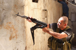 A Sunni Muslim gunman aims his rifle from the neighbourhood of Bab al-Tebbaneh in Tripoli, northern Lebanon