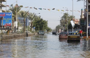 Cars are seen along a flooded street after overnight rain in Baghdad