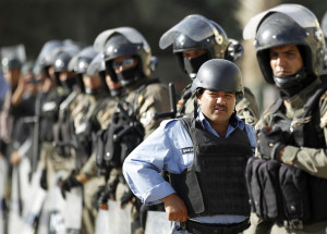 Police dressed in riot gear stand guard during a demonstration calling on the government for press freedom in Baghdad